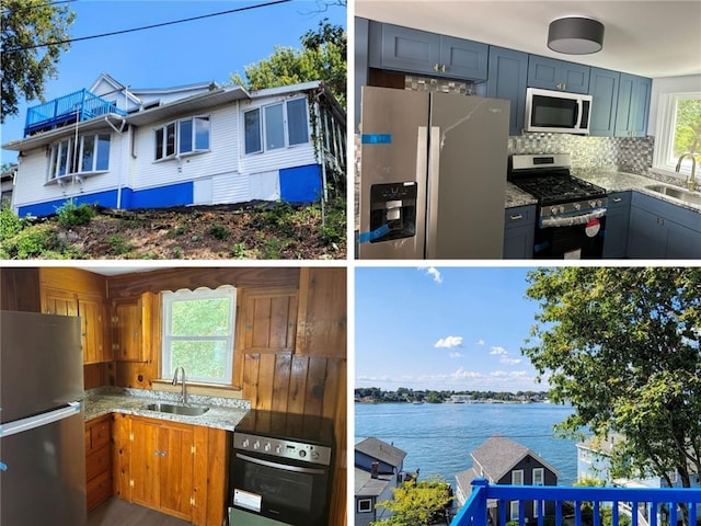 kitchen with light stone countertops, sink, appliances with stainless steel finishes, and a water view