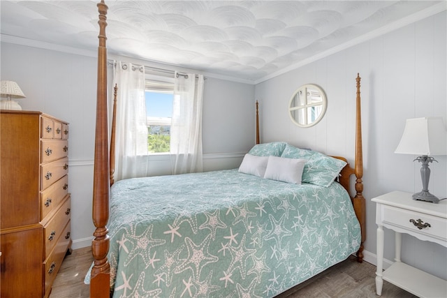 bedroom featuring ornamental molding and wood-type flooring