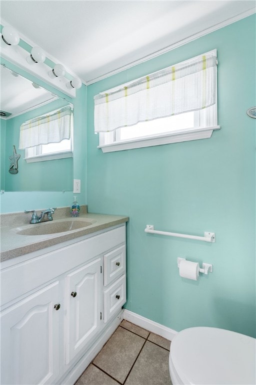 bathroom featuring toilet, tile patterned floors, and vanity