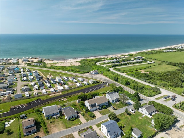 bird's eye view featuring a water view and a beach view