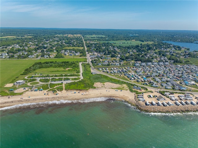 drone / aerial view featuring a water view and a view of the beach