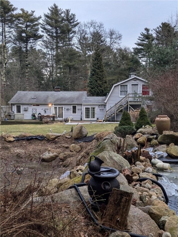 157 Biscuit City Rd, Charlestown, RI 02813 - back of property featuring a yard and stairs
