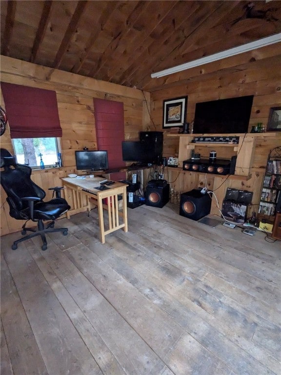 home office with light wood-type flooring, wood walls, wooden ceiling, and lofted ceiling