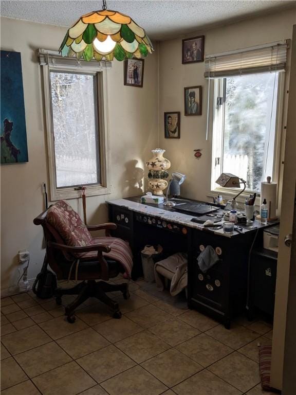 tiled home office with a textured ceiling