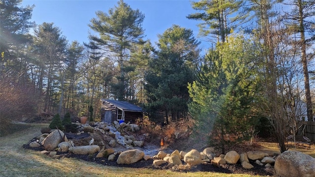 157 Biscuit City Rd, Charlestown, RI 02813 - view of yard featuring an outbuilding and a forest view