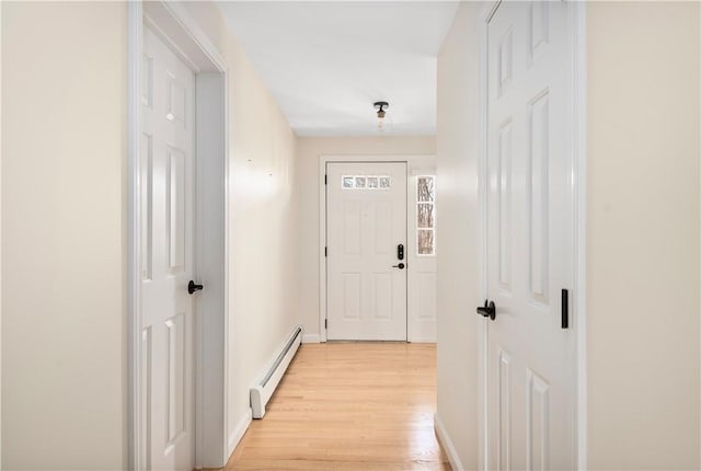 entryway featuring baseboard heating and light hardwood / wood-style flooring