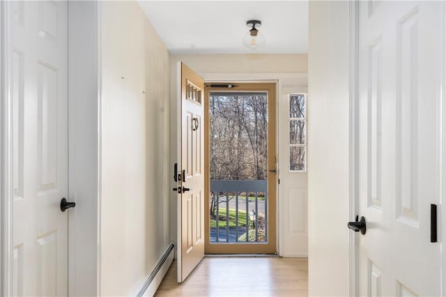 doorway to outside featuring plenty of natural light and light hardwood / wood-style floors