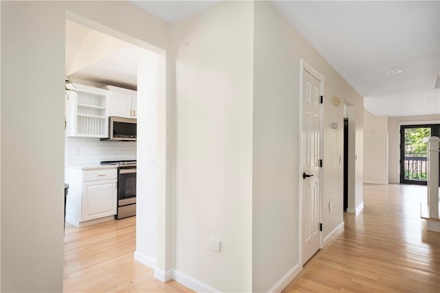 hall with light hardwood / wood-style floors