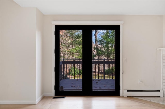 doorway to outside featuring baseboard heating