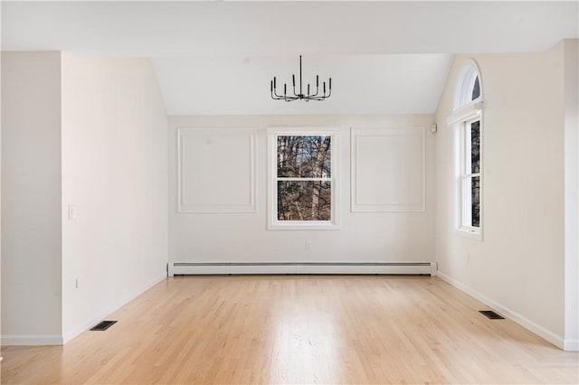 unfurnished room with a chandelier, a baseboard radiator, light hardwood / wood-style floors, and vaulted ceiling