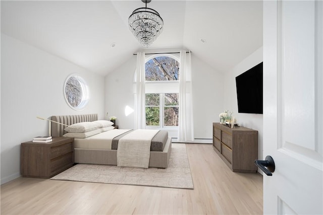 bedroom with vaulted ceiling, an inviting chandelier, and light hardwood / wood-style floors