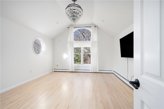 unfurnished living room with a notable chandelier, vaulted ceiling, and light wood-type flooring