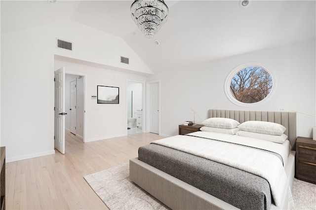 bedroom with light hardwood / wood-style flooring, a chandelier, and vaulted ceiling