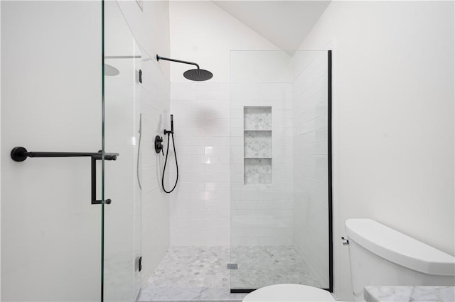 bathroom with toilet and a shower with shower door