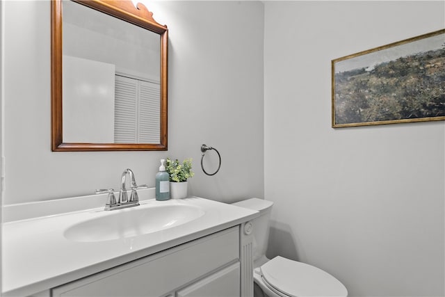 bathroom with toilet and vanity