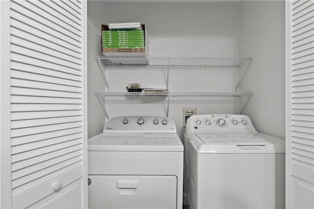 clothes washing area with washing machine and clothes dryer