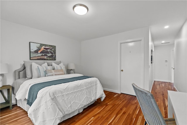 bedroom with hardwood / wood-style floors