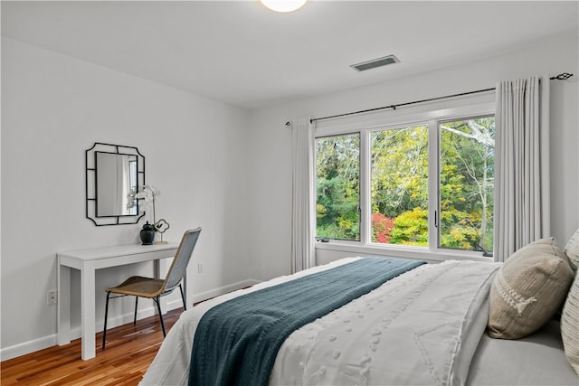 bedroom with hardwood / wood-style flooring