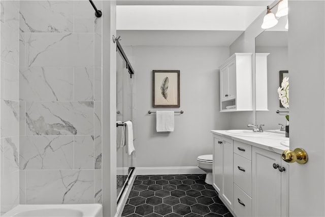 bathroom with a tile shower, toilet, and vanity