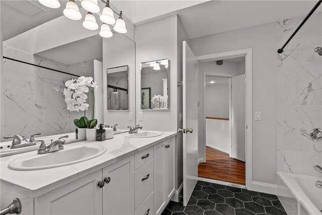 bathroom with vanity, tiled shower / bath, and tile patterned flooring