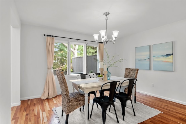 dining room featuring a chandelier and light wood-type flooring