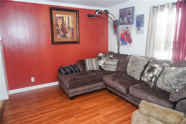 living room featuring wood-type flooring and ornamental molding