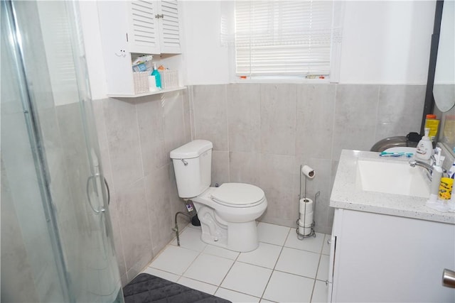 bathroom with tile patterned flooring, vanity, an enclosed shower, and toilet