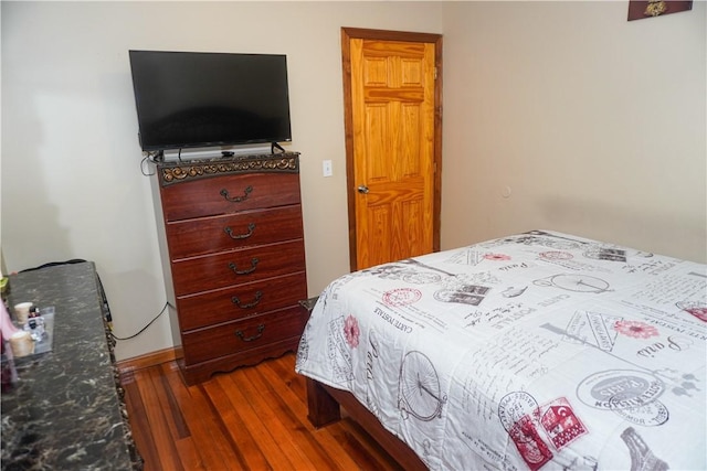 bedroom with dark hardwood / wood-style flooring