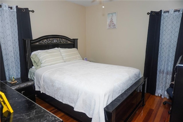 bedroom with dark wood-type flooring