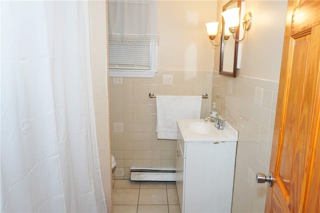 bathroom featuring vanity, a baseboard heating unit, tile walls, and tile patterned floors