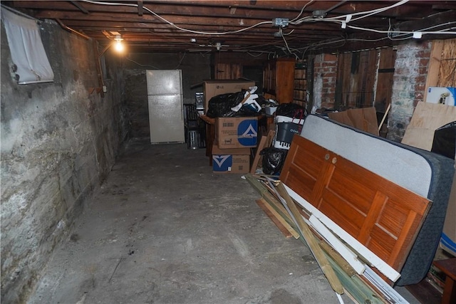 basement featuring white fridge