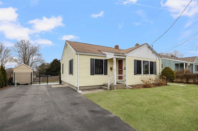 view of front of home featuring a garage and a front lawn