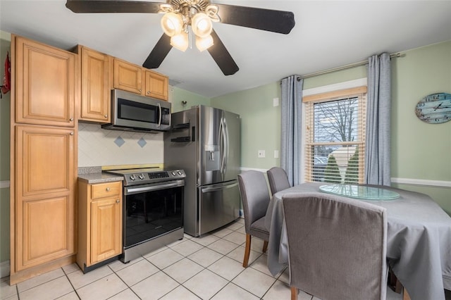 kitchen featuring light brown cabinets, stainless steel appliances, backsplash, ceiling fan, and light tile patterned floors