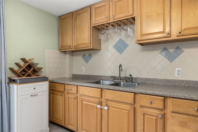 kitchen featuring sink, tasteful backsplash, and light tile patterned flooring