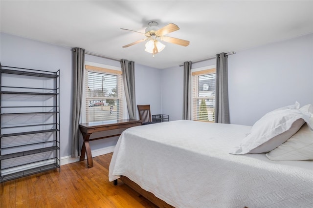 bedroom with ceiling fan and wood-type flooring