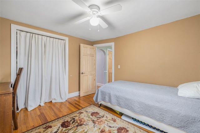 bedroom with ceiling fan and hardwood / wood-style flooring