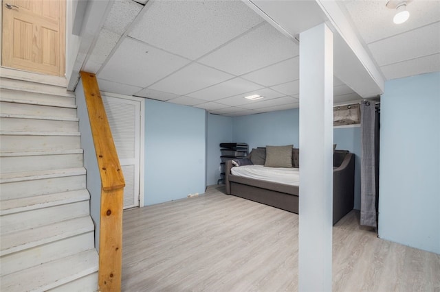 bedroom featuring hardwood / wood-style flooring and a drop ceiling