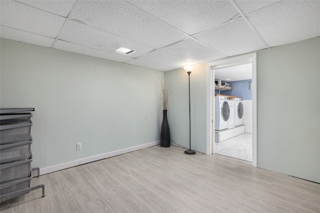 laundry area with washer and dryer and light wood-type flooring