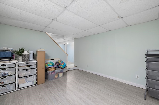 basement featuring hardwood / wood-style flooring and a paneled ceiling