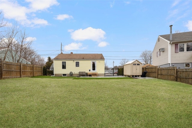 back of property with a yard and a storage unit