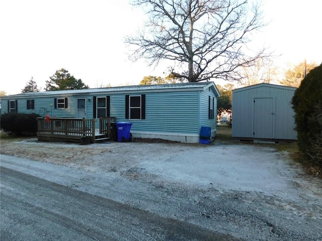 manufactured / mobile home featuring a deck and a storage unit