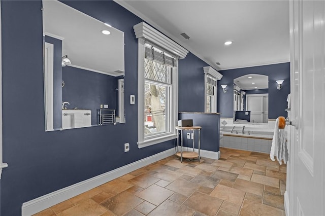 bathroom featuring tiled tub and ornamental molding