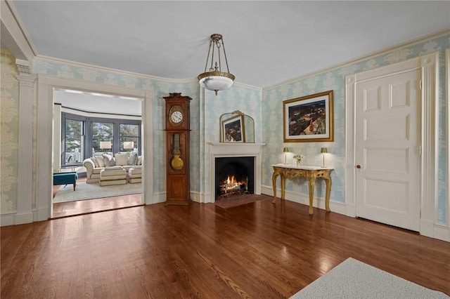 unfurnished living room with crown molding and wood-type flooring