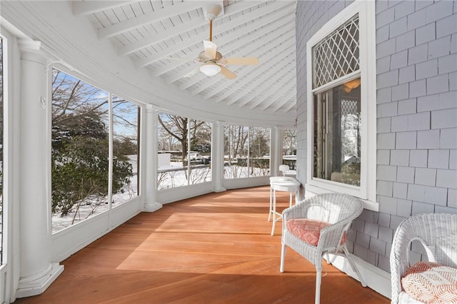 sunroom / solarium with lofted ceiling with beams and ceiling fan