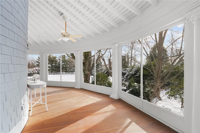 unfurnished sunroom with ceiling fan and beamed ceiling