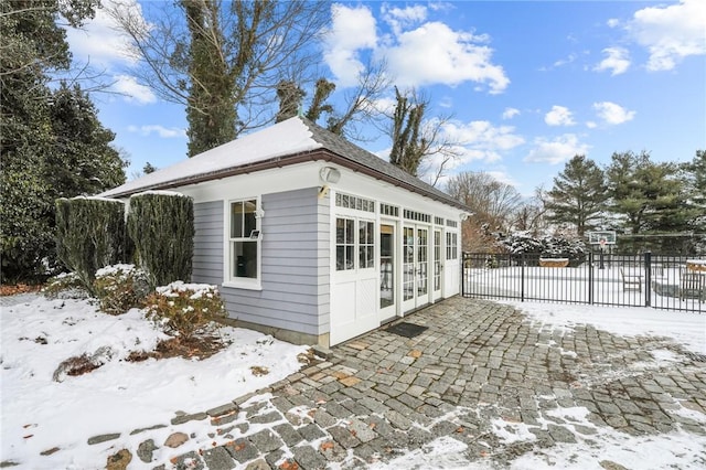 view of snow covered exterior featuring french doors