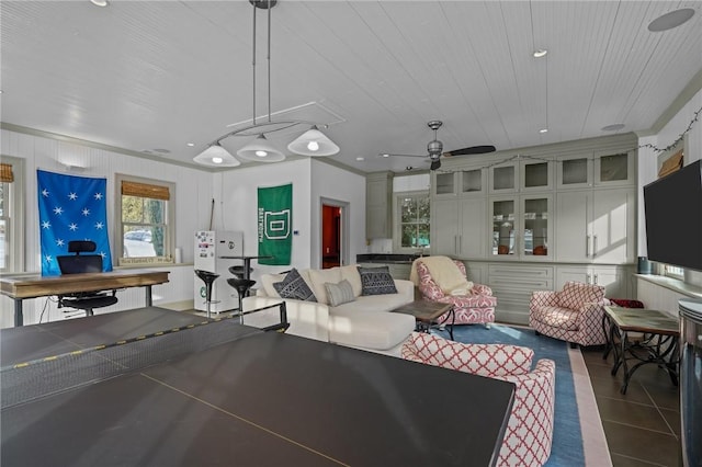 playroom featuring ceiling fan and dark tile patterned floors