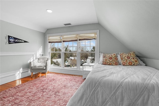 bedroom featuring hardwood / wood-style flooring and vaulted ceiling