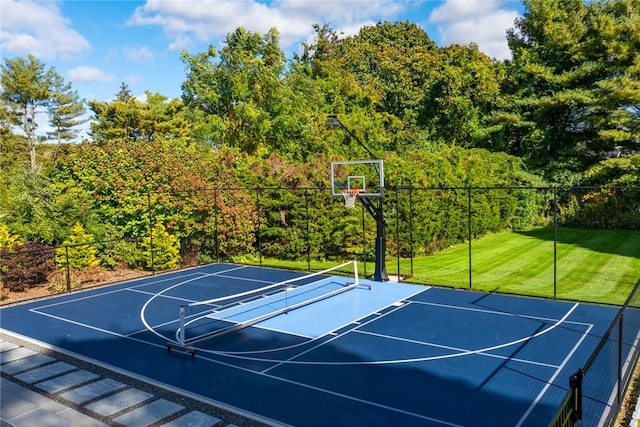 view of sport court with tennis court and a lawn