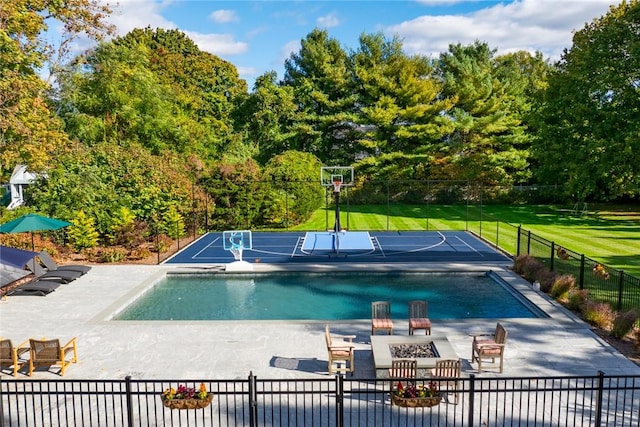 view of pool featuring a fire pit and a lawn